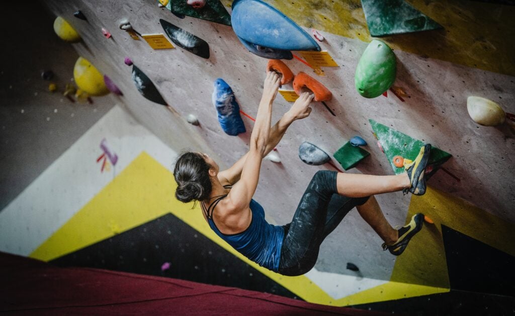 yns plt NY1D4Zni7fc unsplash woman rock climbing on indoor bouldering wall low to the ground