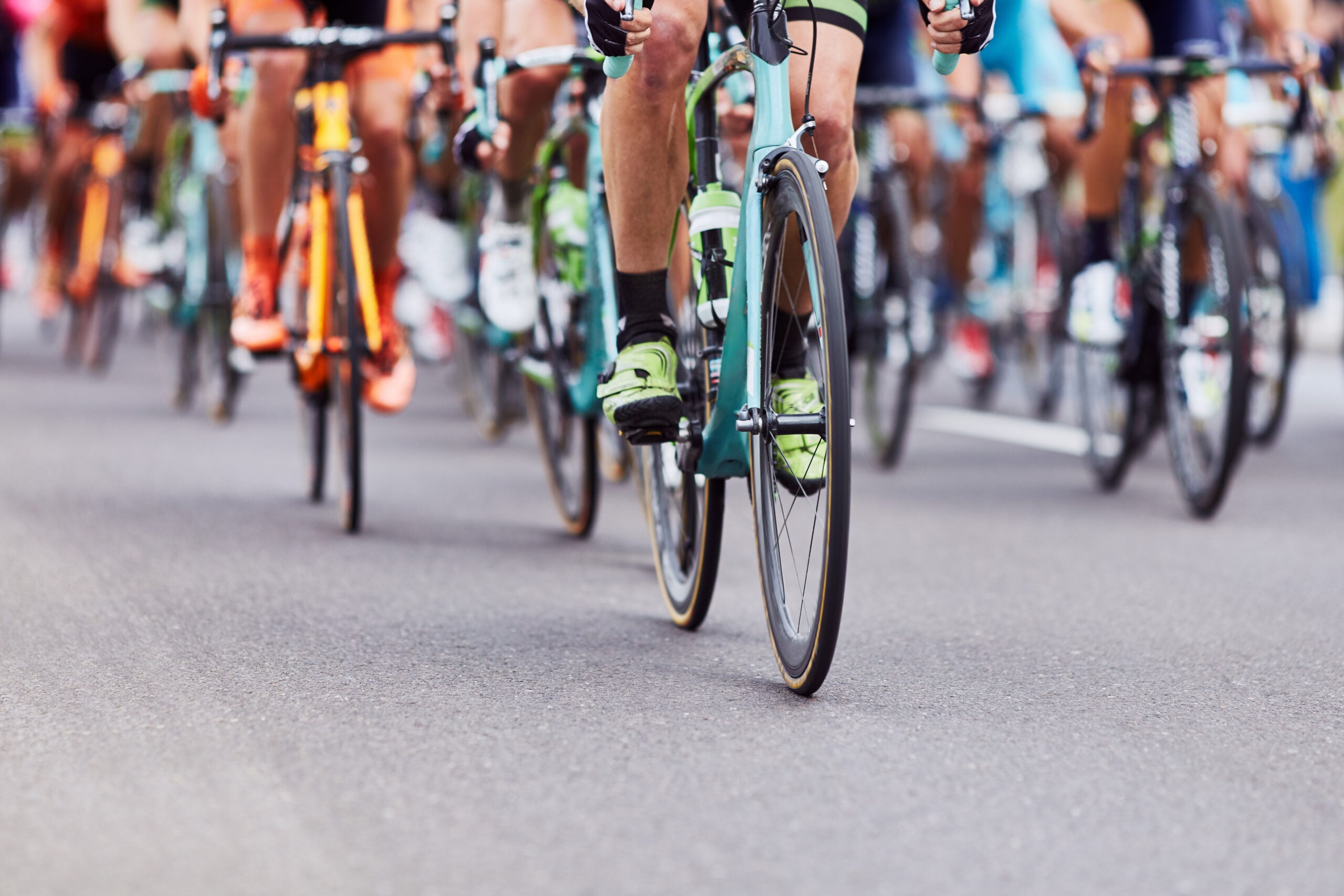 People competing a professional cycling race.|Road cycling photo. Two triathletes train in Italy.
