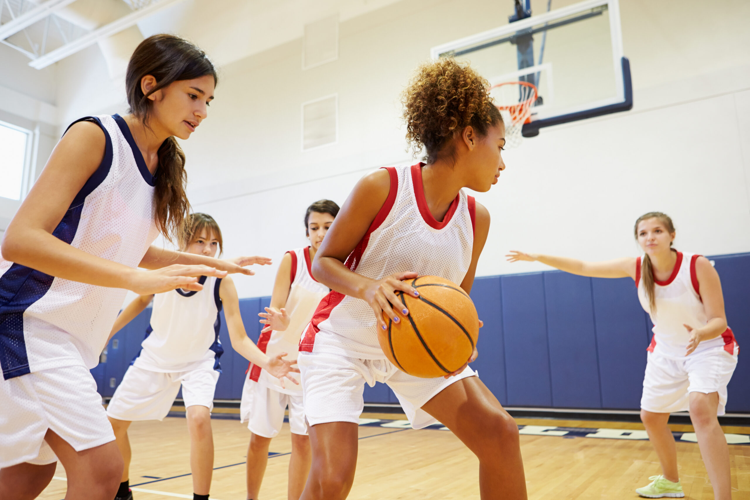 female high school basketball team playing game