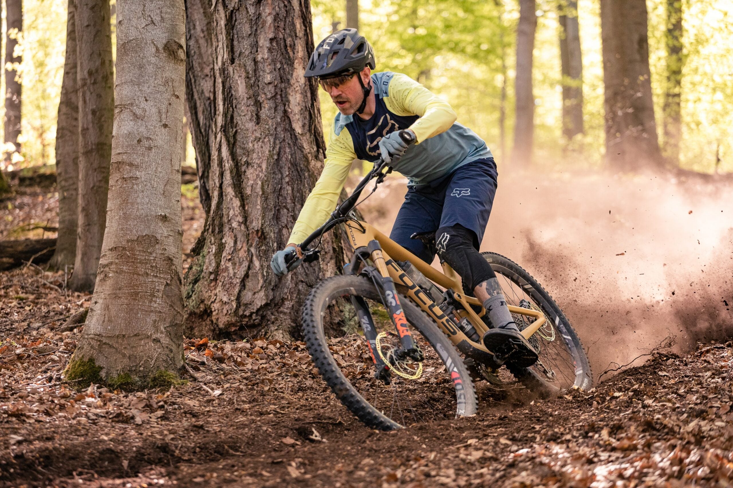 downhill mountain bike rider on a dusty trail|different types of mountain biking with associated injuries.