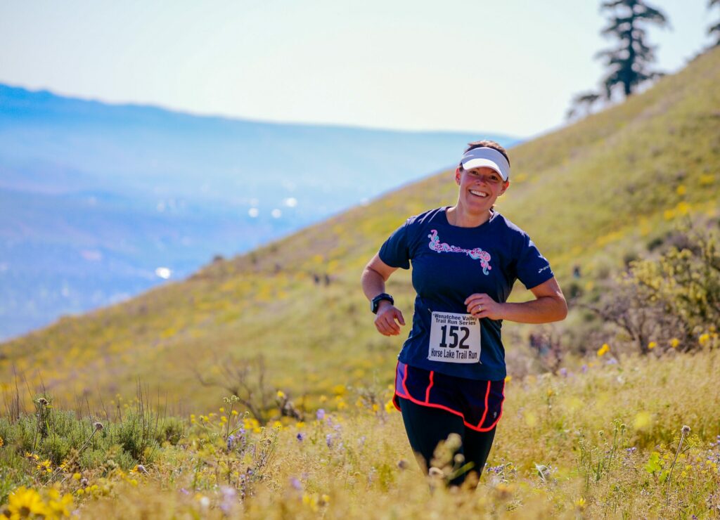 female runner with bib running in the high desert|patellofemoral joint diagram showing the different parts of the knee|image showing the difference between normal knees