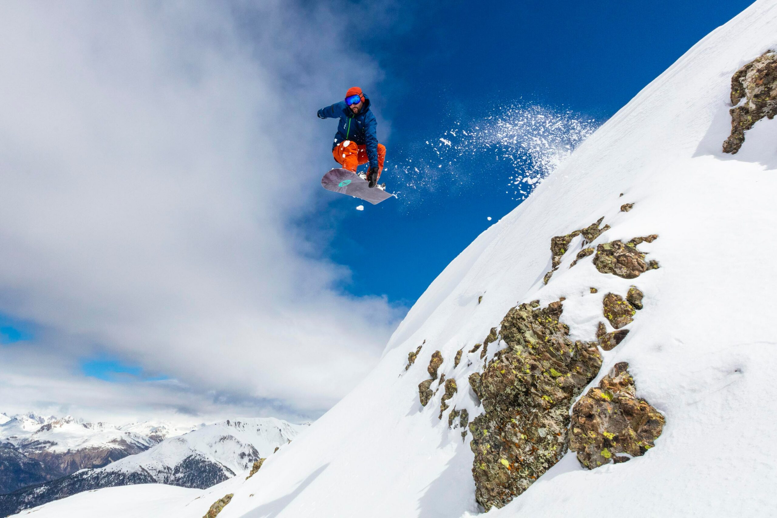 snowboarding jump with blue sky and steep slope|chef chopping peppers in the kitchen|two girls