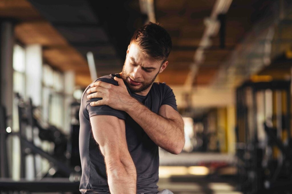 handsome young man feeling the pain in shoulder at the gym|what is the rotator cuff|progression of rotator cuff tears|progression of rotator cuff tears|throwing baseball rotator cuff injury|throwing baseball rotator cuff injury|rotator cuff tear imaging|rotator cuff inury doctor patient|rotator cuff inury doctor patient
