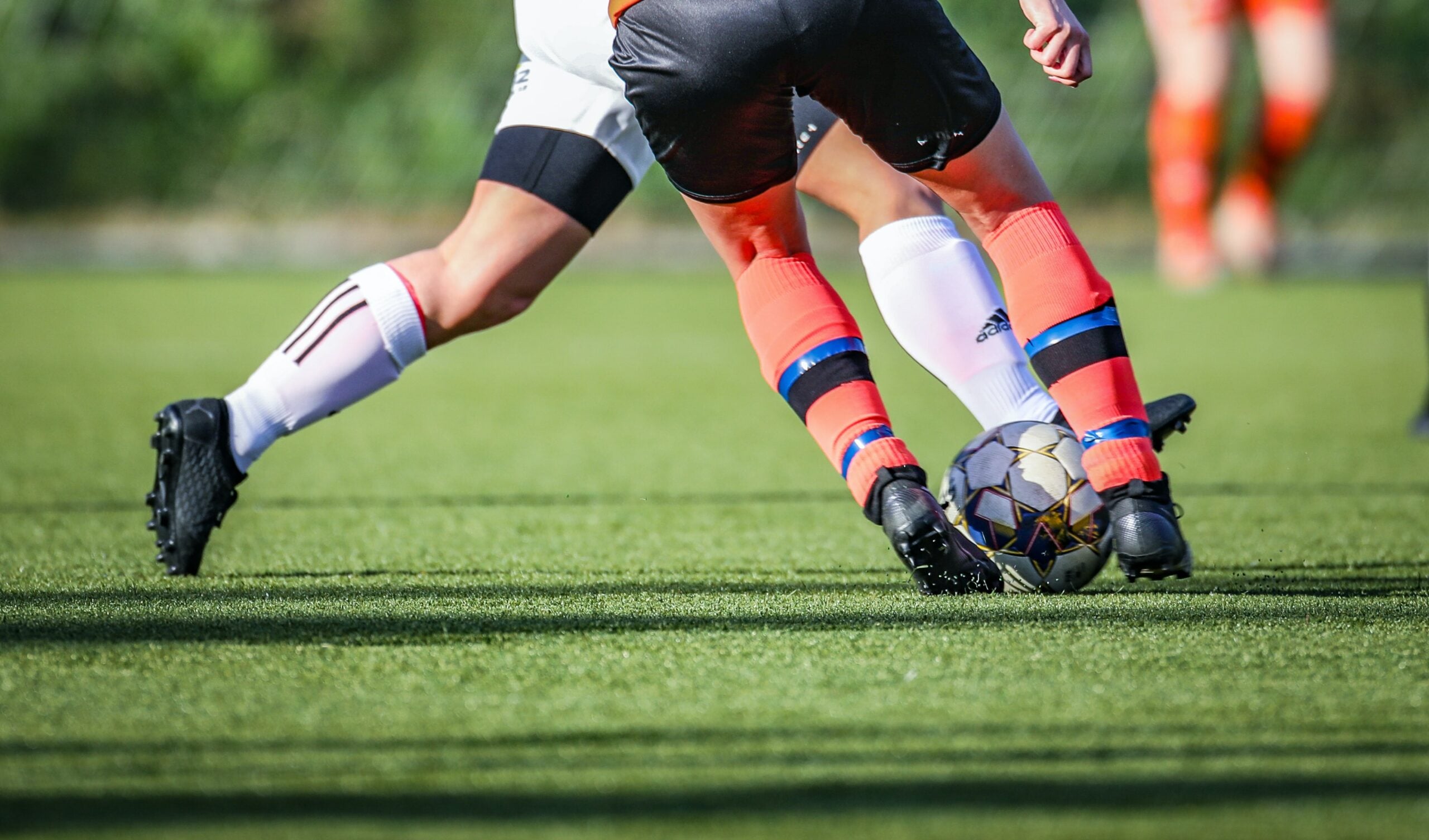 two soccer players running