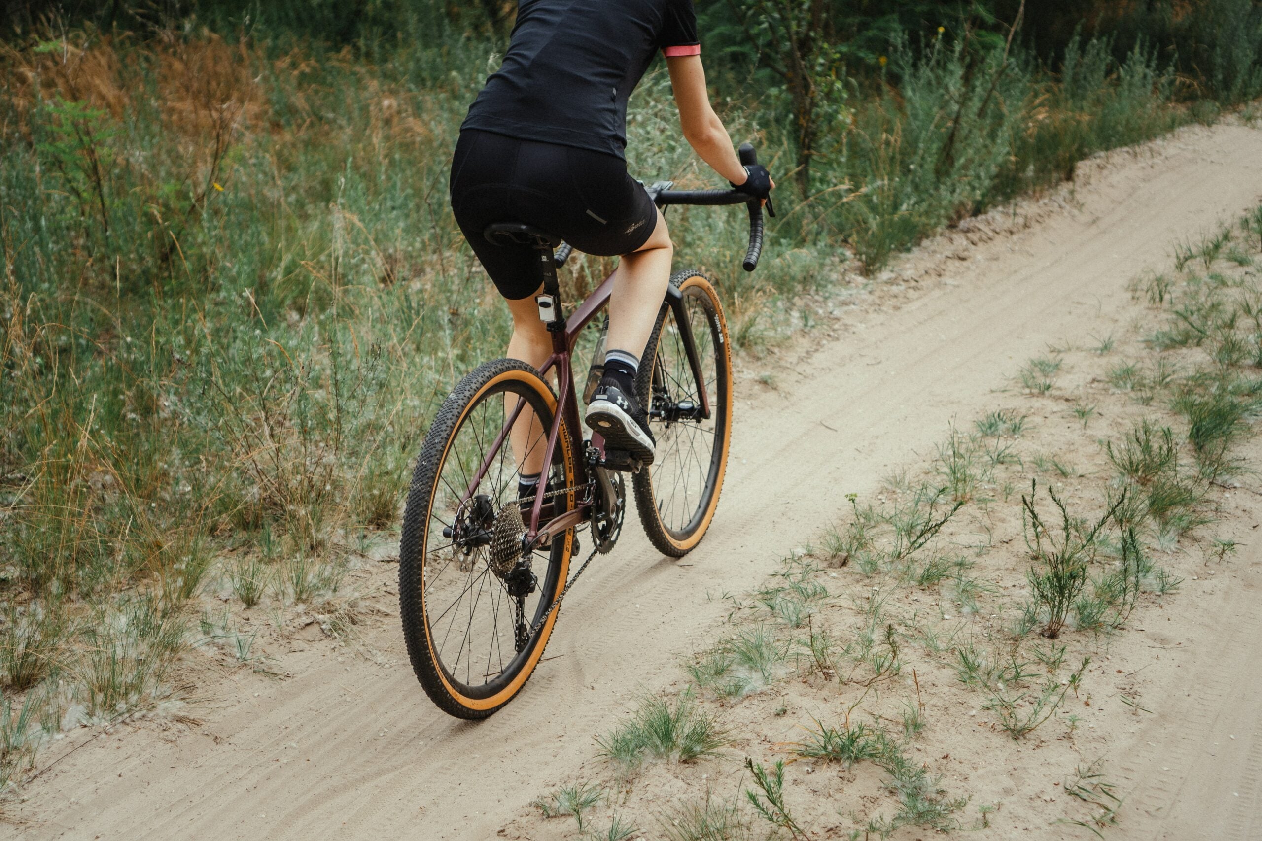 girl cycling on sandy trail|mountain biking in the dry rocky desert|two girls cycling on a paved road girl cycling on sandy trail|mountain biking in the dry rocky desert|two girls cycling on a paved road