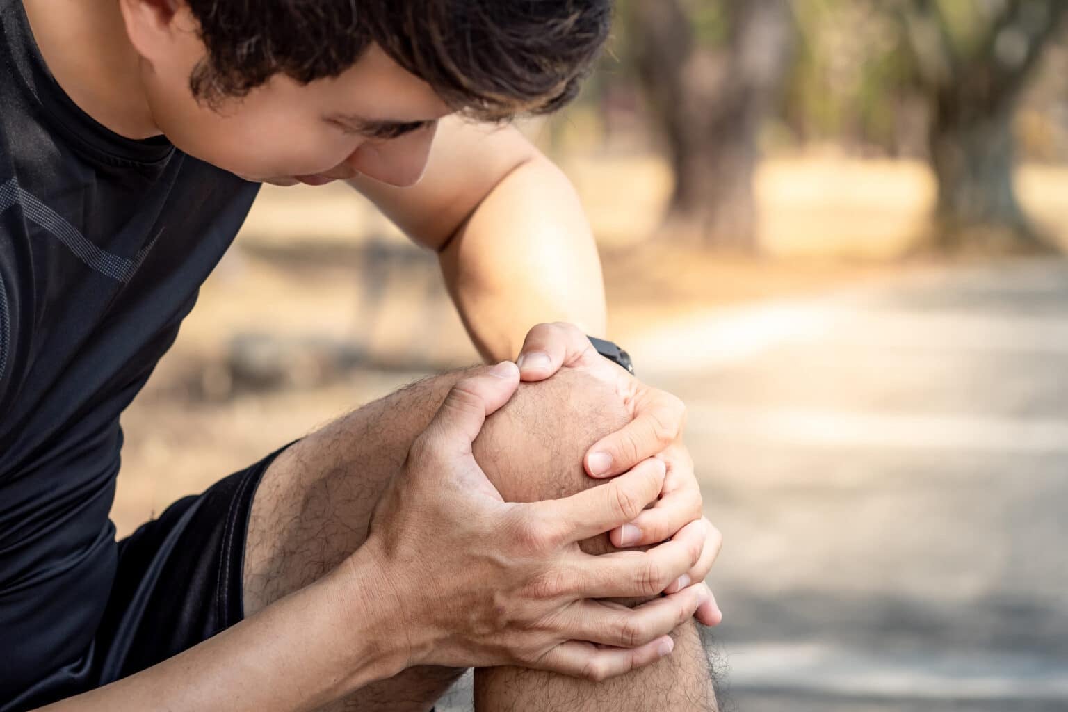 Athlete man feeling knee pain or rheumatoid arthritis while doin