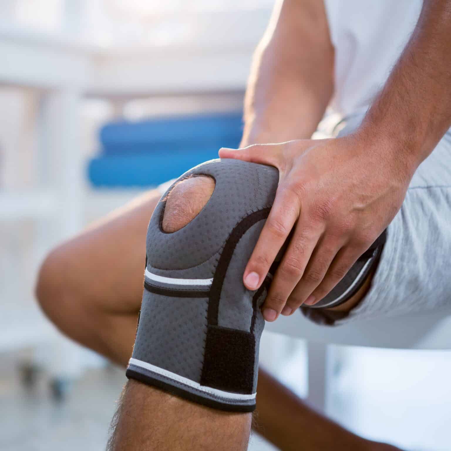 Mid section of man with knee injury