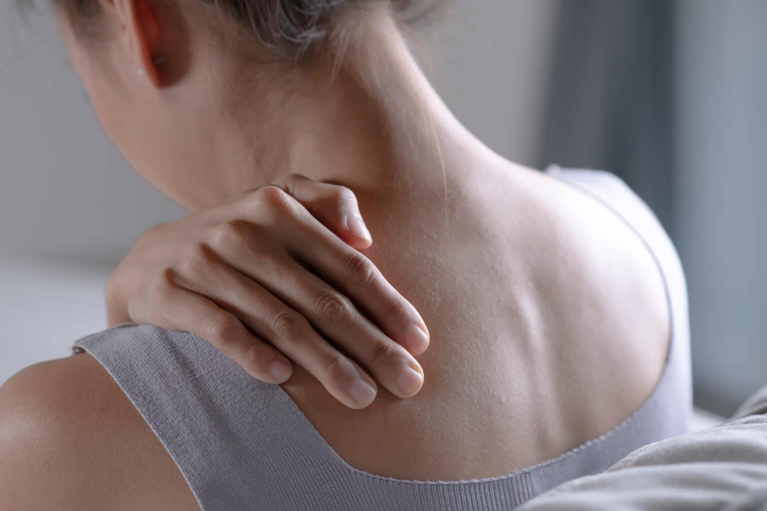 Asian woman has shoulder pain. Female holding painful shoulder with another hand. People with body-muscles problem, Healthcare And Medicine.